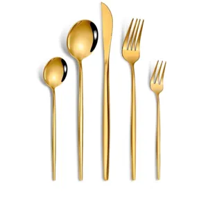 Detailed view of luxury golden stainless steel cutlery set including knife spoon and fork