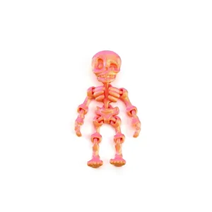 Detail view of 3D printed articulated skeleton toy featuring a dreamy orange gradient.