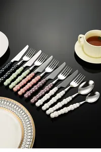 Detailed macro view of colorful pearl ceramic handle stainless steel cutlery set