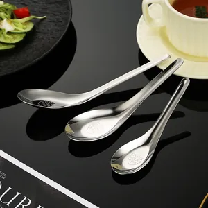 Three 304 stainless steel flat bottom soup spoons set on a black glossy tabletop