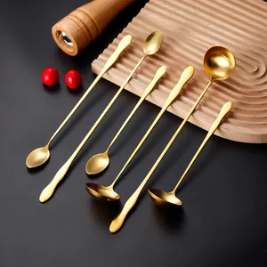 Long handle golden stainless steel spoon set on wooden board