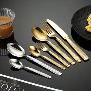 Elegant gold and silver stainless steel cutlery set with fluted Roman column handles.