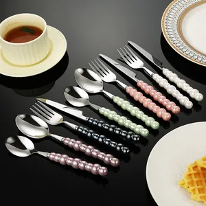 Elegant 304 stainless steel cutlery set featuring creative colorful pearl ceramic handles