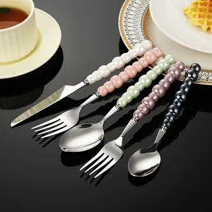Elegant stainless steel cutlery set with unique pearl glaze ceramic beaded handles.