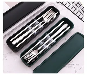 Detailed view of portable stainless steel cutlery sets in black and dark green storage cases.