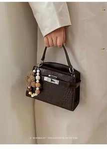 Elegant brown crocodile embossed small square handbag with a pearl and flower charm detail