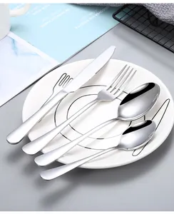 Detail of a 4-piece stainless steel cutlery set with a knife, fork, and spoons on a white plate.