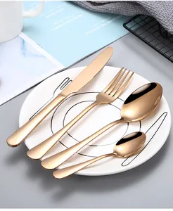 Detailed macro view of 4-piece rose gold stainless steel cutlery set on a white ceramic plate
