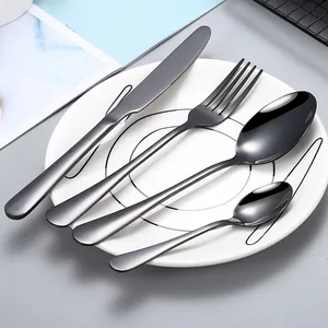 Modern 4-piece black stainless steel flatware set with knife fork and spoons on a plate