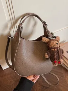 Elegant taupe pebbled leather bucket bag for women with a cute plush bear charm