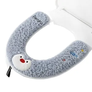 Soft plush U-shaped toilet seat cover with cute cartoon penguin and fish design.