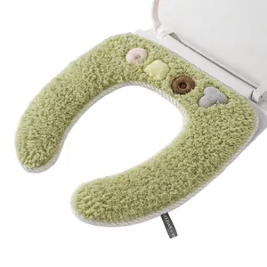 Plush green toilet seat cover with cute decorative patterns for winter home use