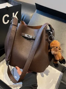 Vintage brown pebbled leather bucket bag with cute plush donkey charm accessory
