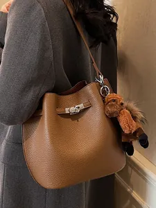 Retro brown leather bucket bag for women, stylish crossbody handbag with horse charm