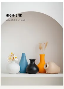 Close-up of five modern colorful ceramic vases in various shapes and matte finishes
