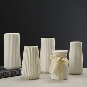 Set of minimalist white ceramic vases with ribbed and diamond textured designs for home decor