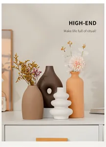 Minimalist ceramic vases in neutral tones for elegant home office or table decoration.