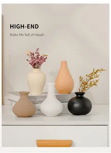 Minimalist ceramic vase set in matte earth tones displayed on books for home decor