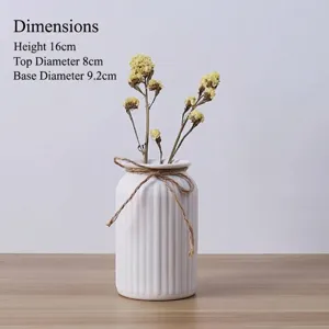 Elegant white ribbed ceramic vase with twine bow, 16cm tall for home decor accents.