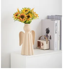 Elegant angel-shaped ceramic vase with sandy texture in a modern home decor setting