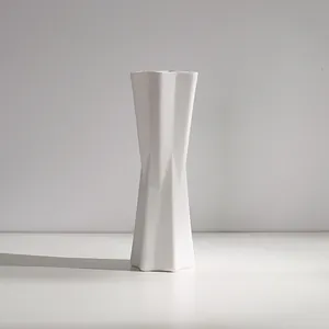 Modern minimalist white ceramic vase with geometric faceted design for elegant home decor