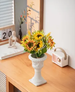 Vintage roman column vase with sunflowers on a wooden table decoration