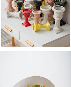 Close-up of colorful Roman column ceramic vases on a white desk