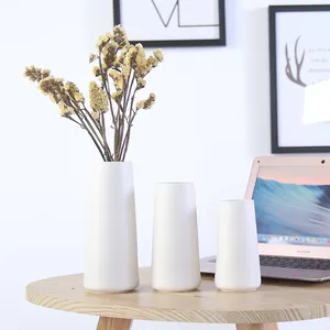 Elegant set of three minimalist modern white ceramic vases for stylish home decoration