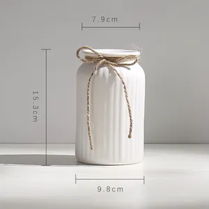 Detail view showing dimensions of white ribbed ceramic flower vase.
