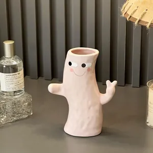 Minimalist pink hand-holding ceramic vase for stylish home flower arrangement decor