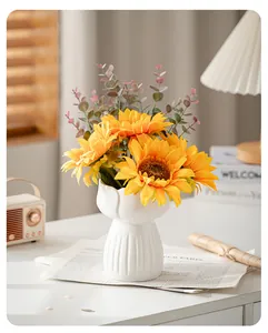 Elegant white ceramic ribbed vase with yellow sunflowers for modern home decoration