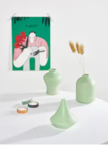 Three small light green ceramic vases styled on a white table with a green poster backdrop.