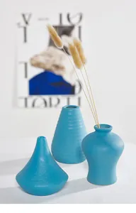 Detail of blue matte ceramic vases with dried flowers for Nordic minimalist home decor