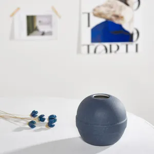 Modern minimalist blue spherical ceramic vase with textured finish for home decoration