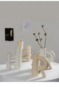 Group of textured off-white ceramic vases in unique shapes for modern home decor