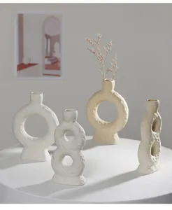 Detailed view of white textured ceramic vases in a minimalist Nordic style.