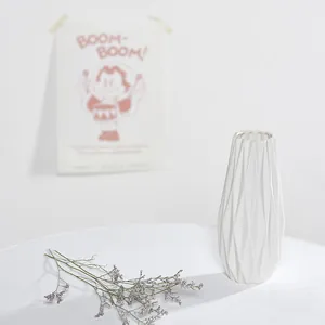 Jarrón de cerámica blanca minimalista con textura geométrica para decoración hogar.