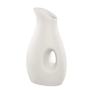 Modern minimalist white ceramic flower vase with unique abstract hollow center design for decor