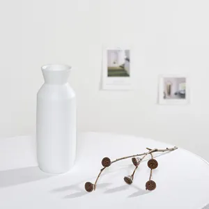 Vase en céramique blanche minimaliste pour la décoration sur surface blanche