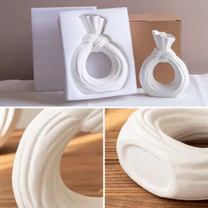 Modern white circular knotted ceramic vase for elegant home decor with protective packaging
