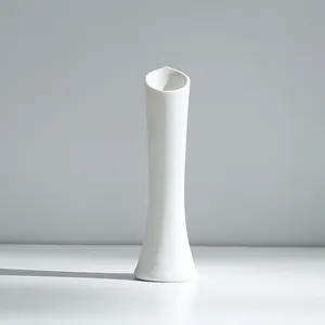 Detail view of a white ceramic vase with subtle ribbed texture for modern home decor