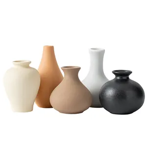 Set of five minimalist ceramic vases with matte textured finish in neutral earthy tones