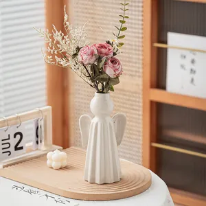 Elegant white ceramic angel vase with wings for minimalist modern home decoration