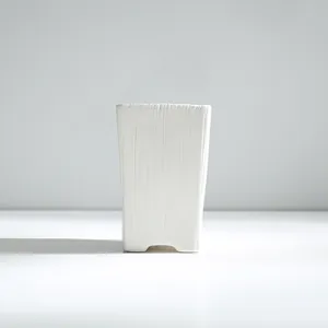 Minimalist white ceramic succulent planter with a textured vertical ridge design