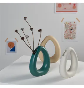 Nordic minimalist ceramic vases in teal and beige, perfect for abstract home decor