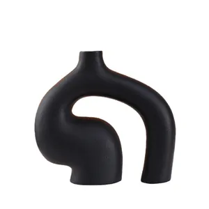Modern minimalist black ceramic vase with abstract geometric design for home decor