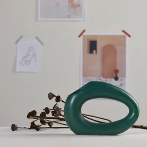 Modern Nordic abstract oval ceramic vase in deep green for minimalist home decor