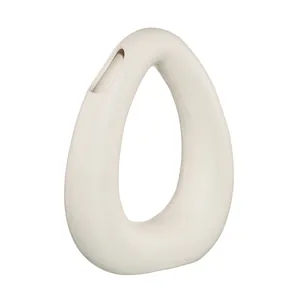 Minimalist Nordic white ceramic vase featuring an asymmetrical hollow ring design