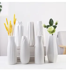 Collection of minimalist white ceramic vases with various textures for home decoration