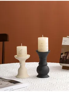 Pair of minimalist ceramic candle holders in black and cream for elegant home decor